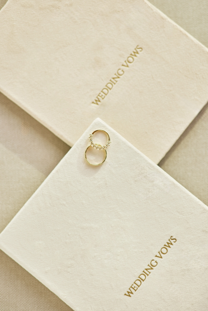 Wedding vow books with gold lettering and wedding rings — symbol of marriage vows.